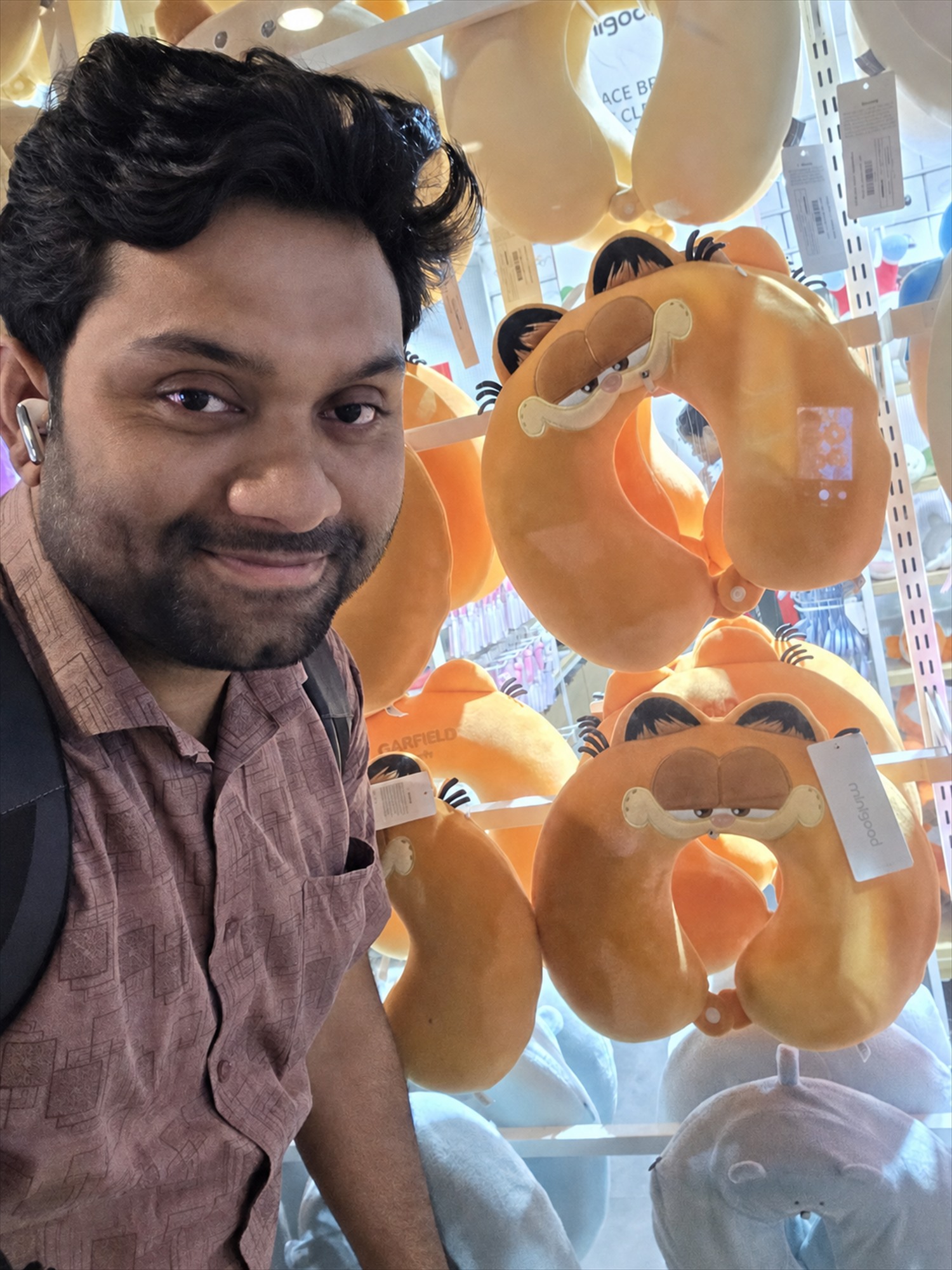 Selfie beside Garfield travel pillows.