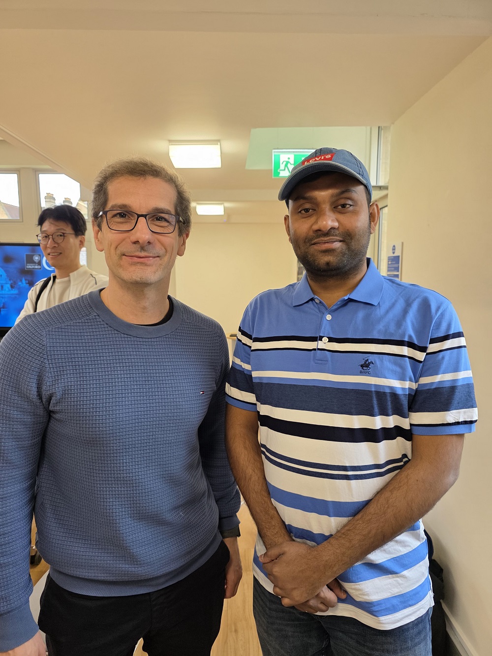 Engaging in deep technical discussions with Prof. Bernardo Cuenca Grau from the University of Oxford.